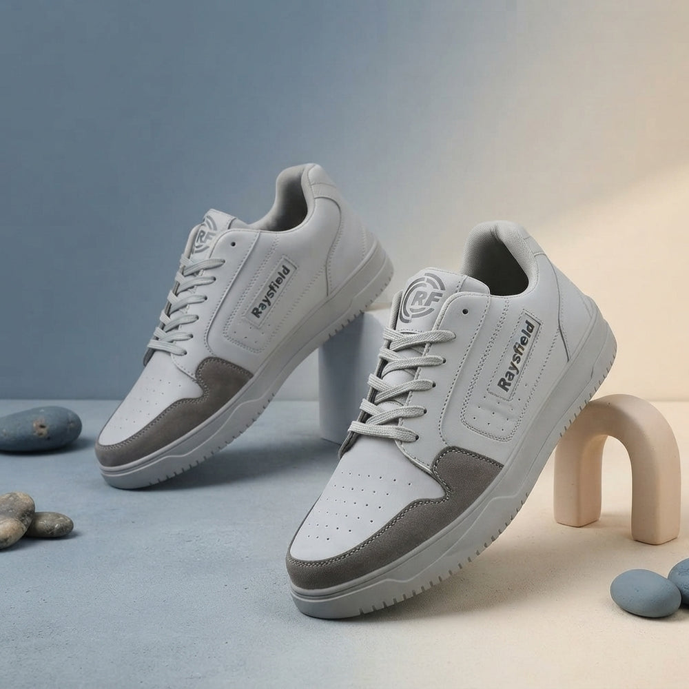 A pair of Anjrs men's running shoes displayed on a professional studio background with slate blue and warm cream gradients.